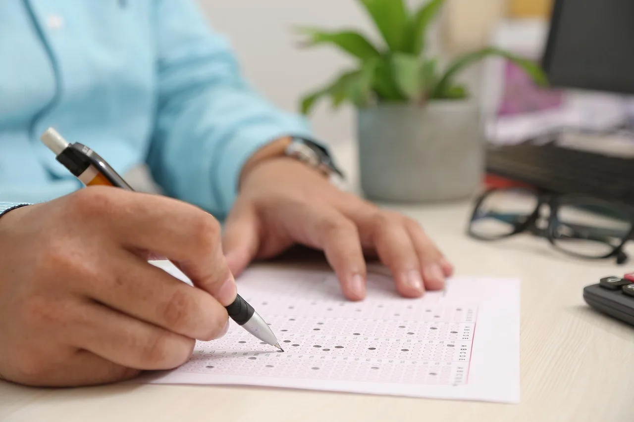 test paper, answering, hand, note, filling sheet, filling form, test paper, test paper, test paper, test paper, test paper. State tax preparer engagement letters: what to include